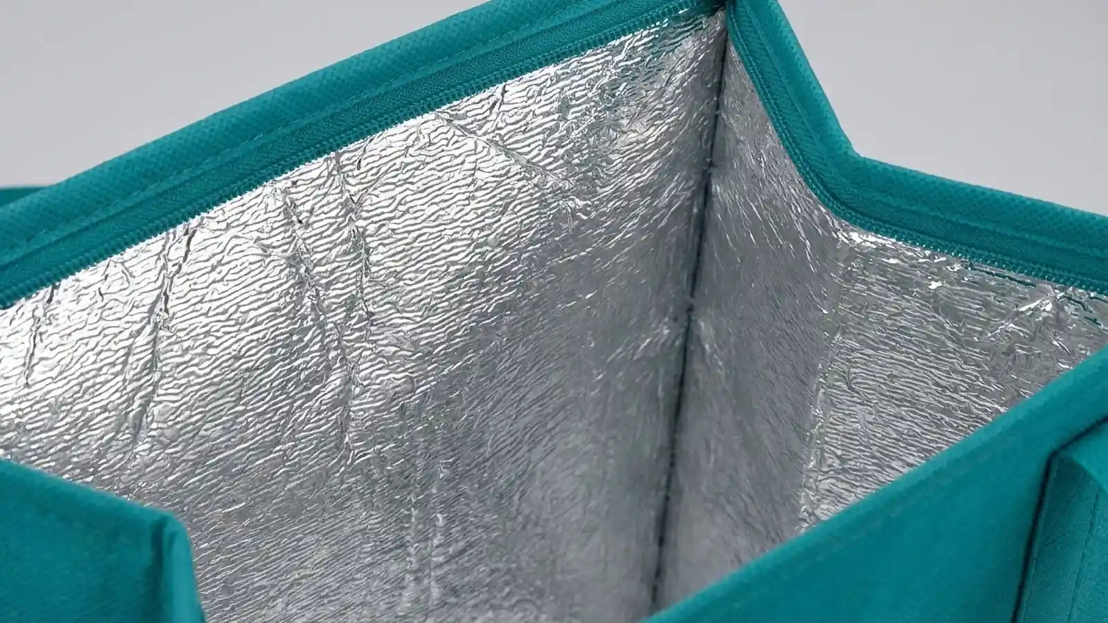 Thermal foil interior lining of custom insulated cooler tote bag keeping food hot or cold