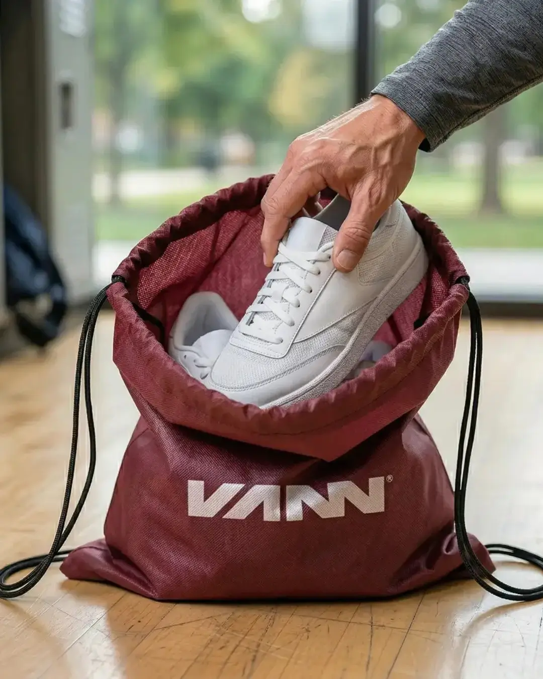 Custom drawstring bags in several colors with a sample printed logo, lifestyle view