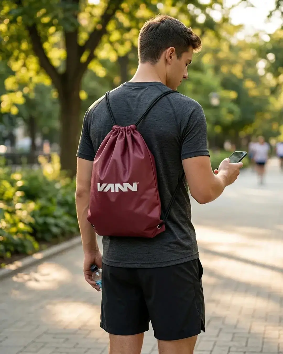Custom drawstring bags with a sample printed logo worn on the shoulders at a sports event