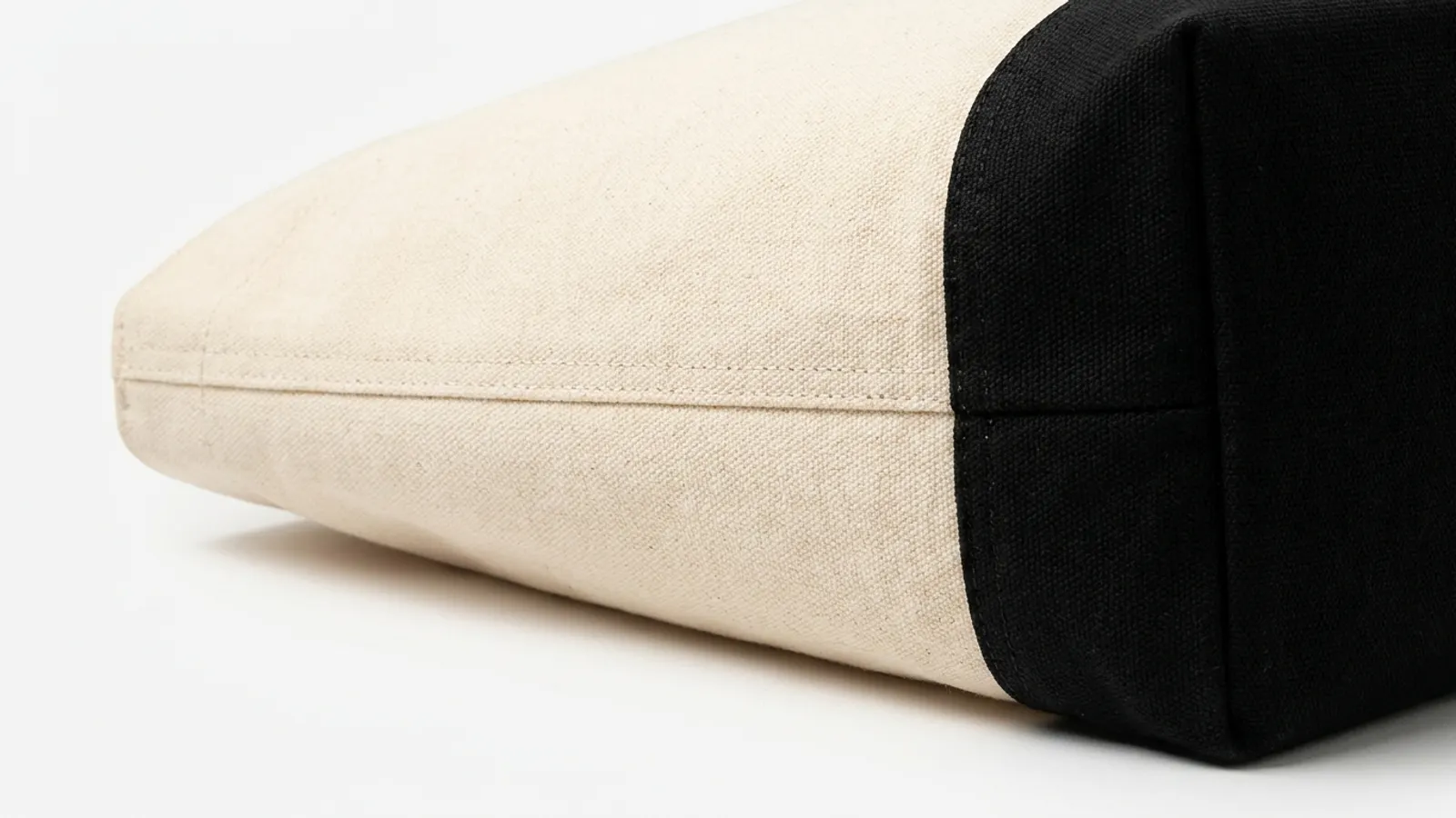 Contrast base panel detail showing the seam between natural cream canvas body and contrasting bottom panel