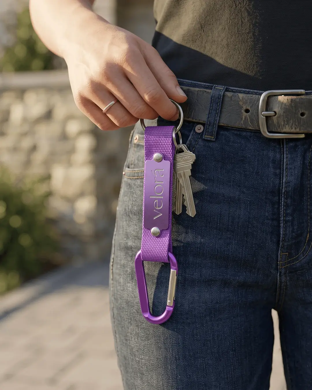 Custom carabiner keychain mockup, purple with an engraved plate on a belt loop with keys