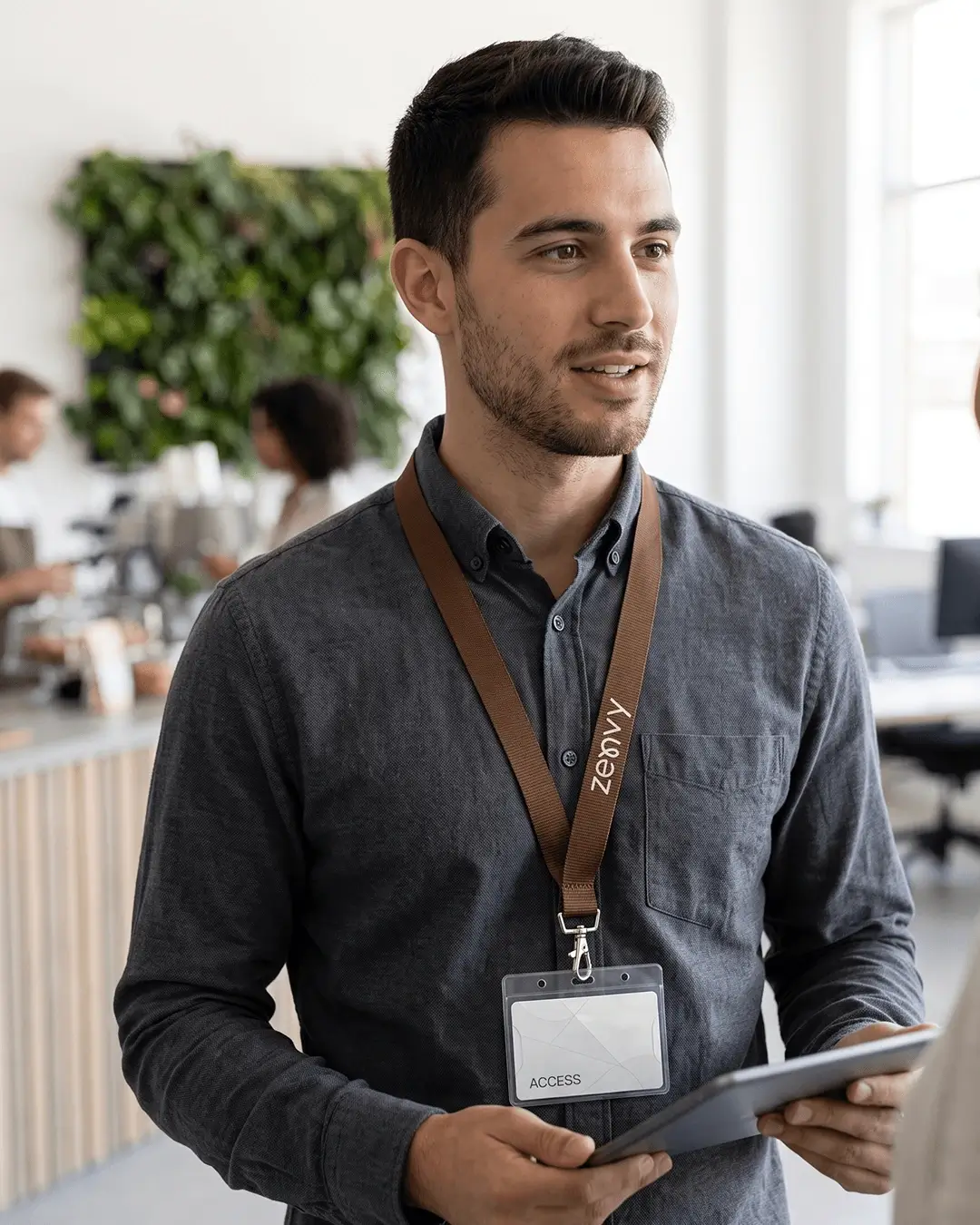 custom lanyards printed edge to edge with a sample full color design, brown strap, worn by a man in an office with an id badge, lifestyle view