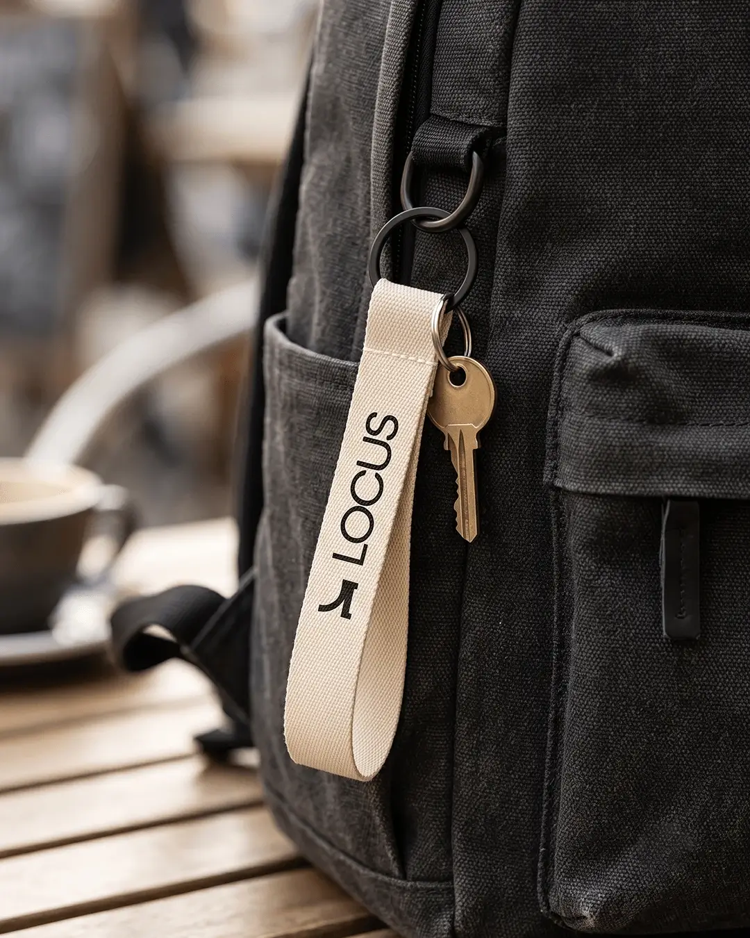 Custom wrist lanyards in navy blue with a white printed logo and a key ring