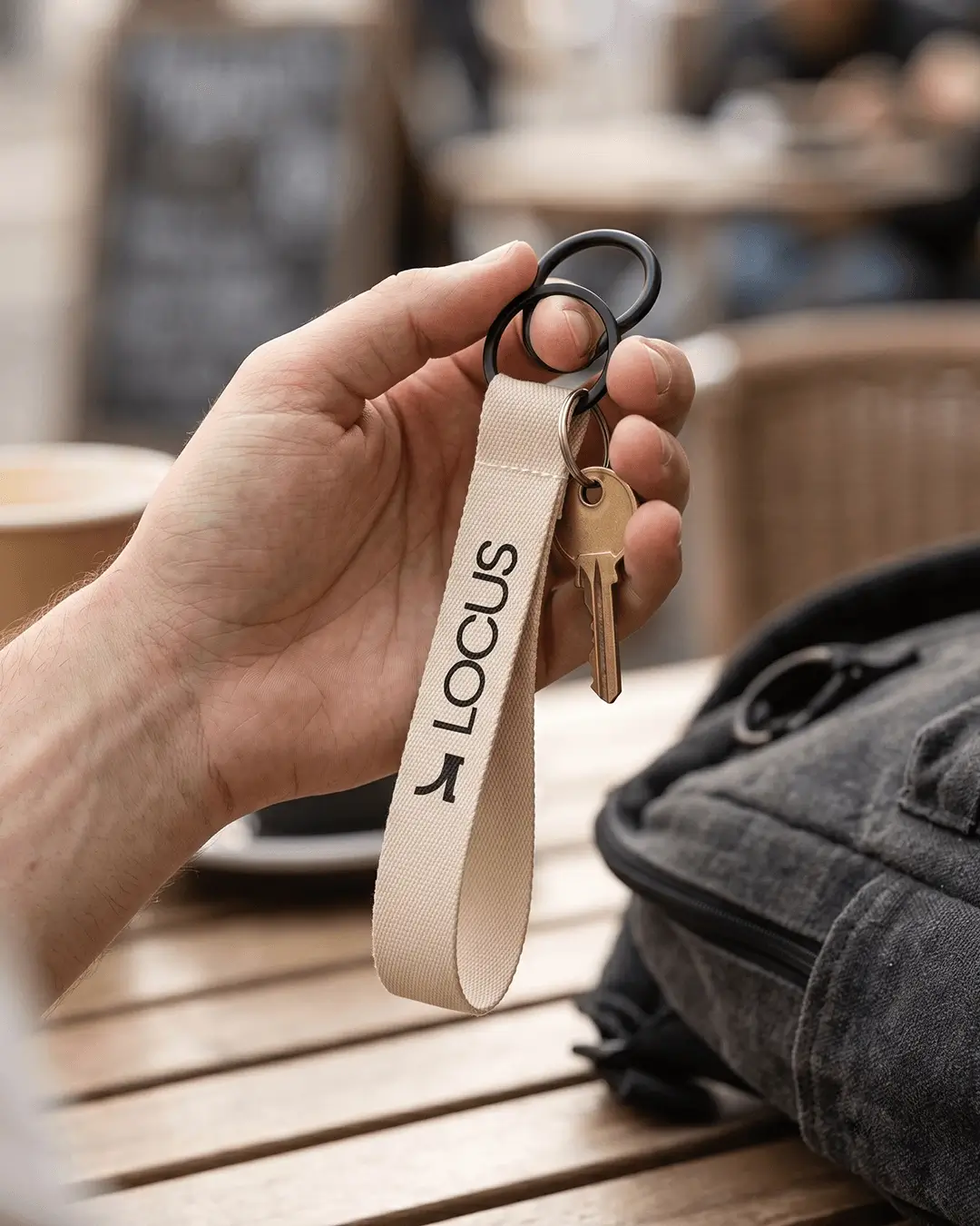 Custom wrist lanyards with a lobster claw attachment holding keys and a badge