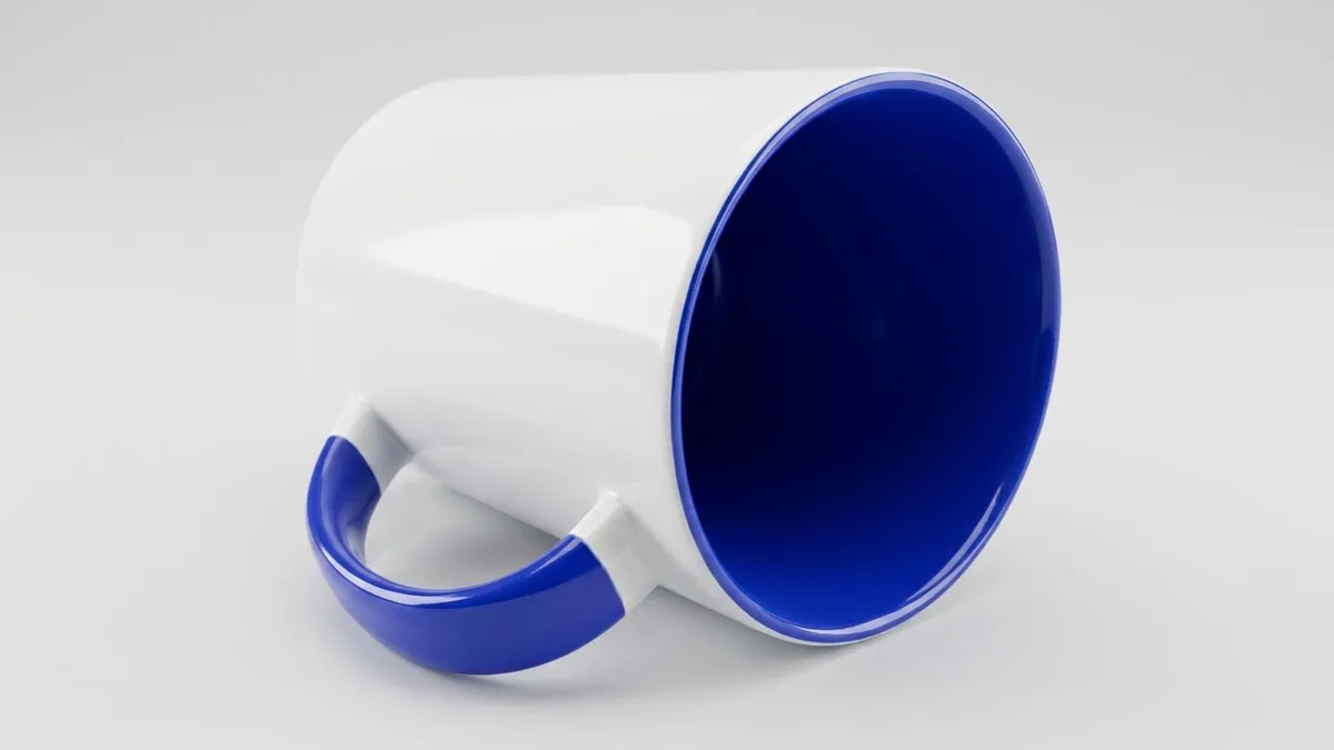 Two-tone detail of a custom ceramic latte mug — glossy white exterior with a colored interior and handle by Brandevois