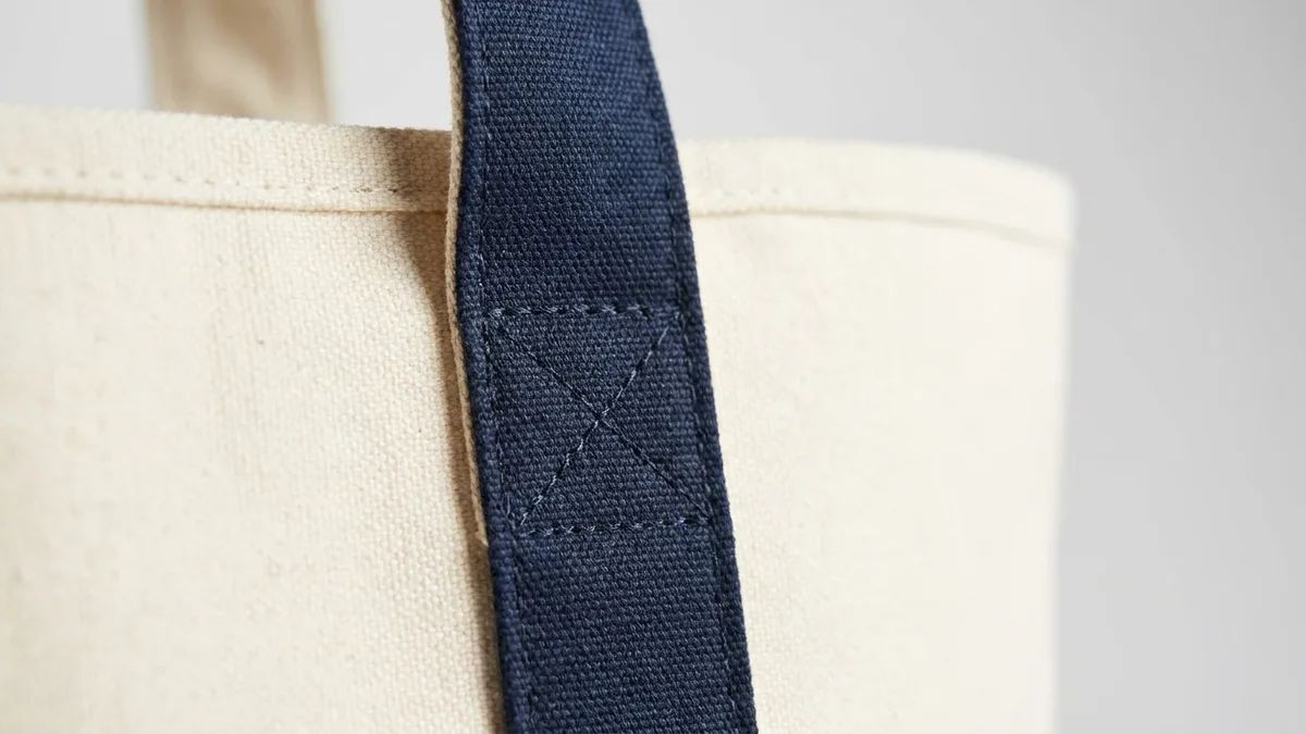 Self-contrasting reinforced cotton carry handle stitched to the canvas body of a custom boat tote bag — Brandevois
