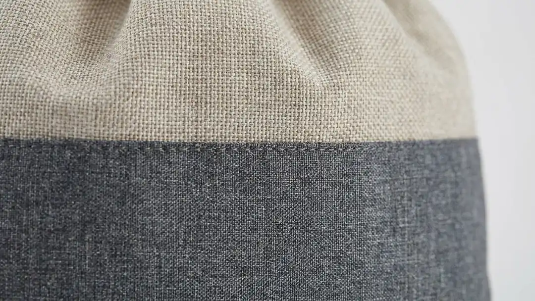 Two-tone heathered 300D polyester body and faux-jute top panel detail of a custom cinch backpack — Brandevois