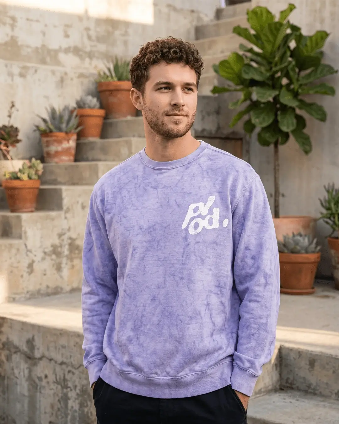 Custom crewneck sweatshirts in Colorblast, garment-dyed crewneck with a sample printed design, worn