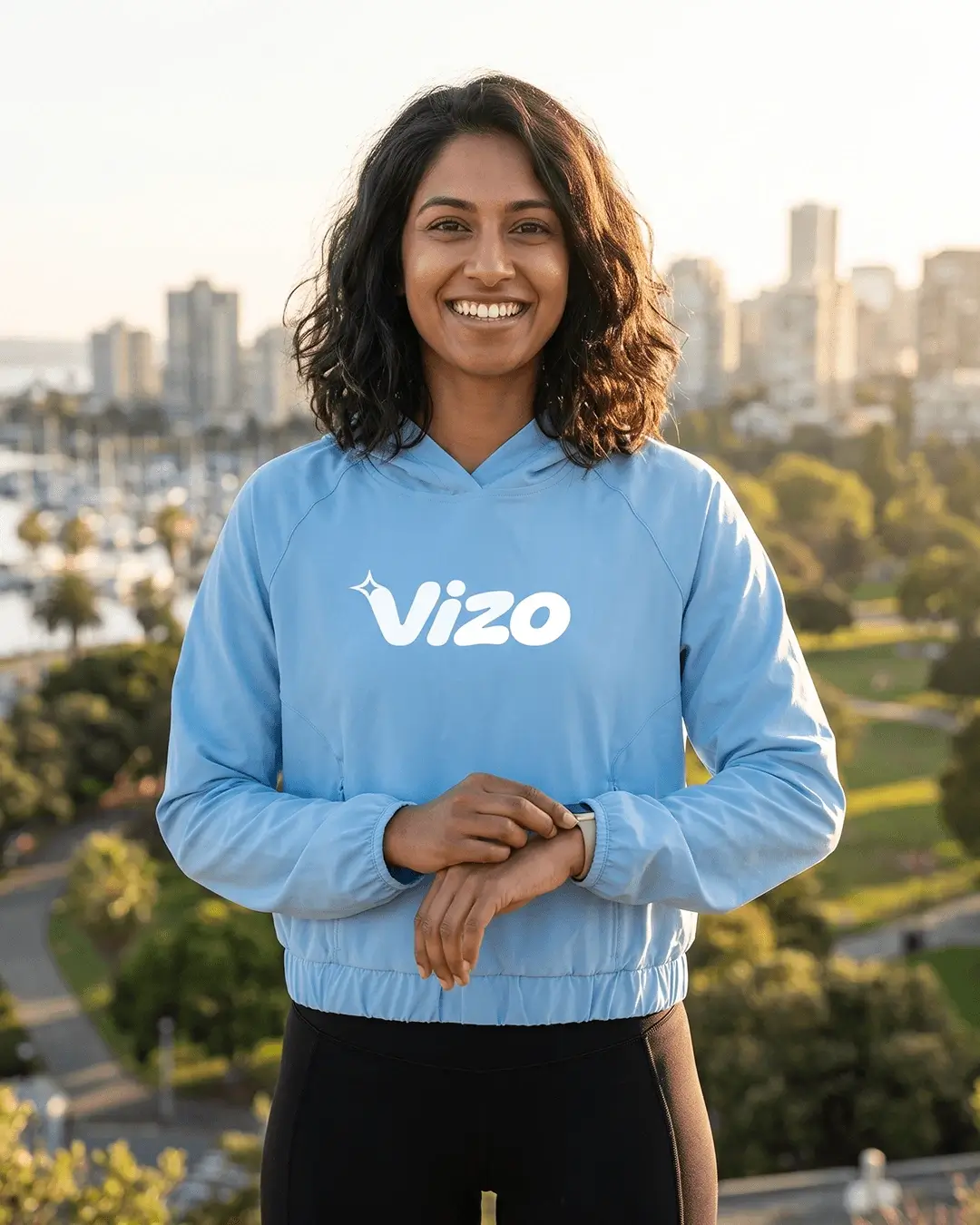 Custom sun shirts, Columbia Blue UPF 50+ hooded pullover with a chest logo worn outdoors at golden hour