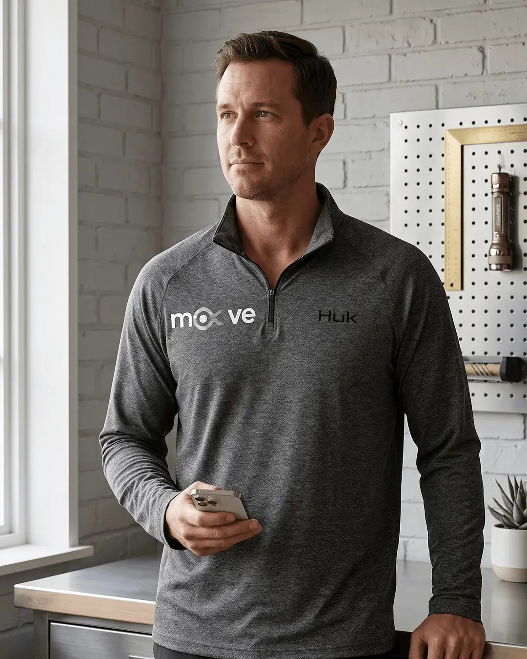 Custom embroidered quarter zips, HUK Airweight pullover with a sample embroidered logo, worn