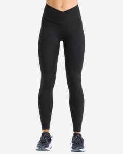 Model wearing custom leggings in Black from the front, showing the high rise and crossover waistband fit