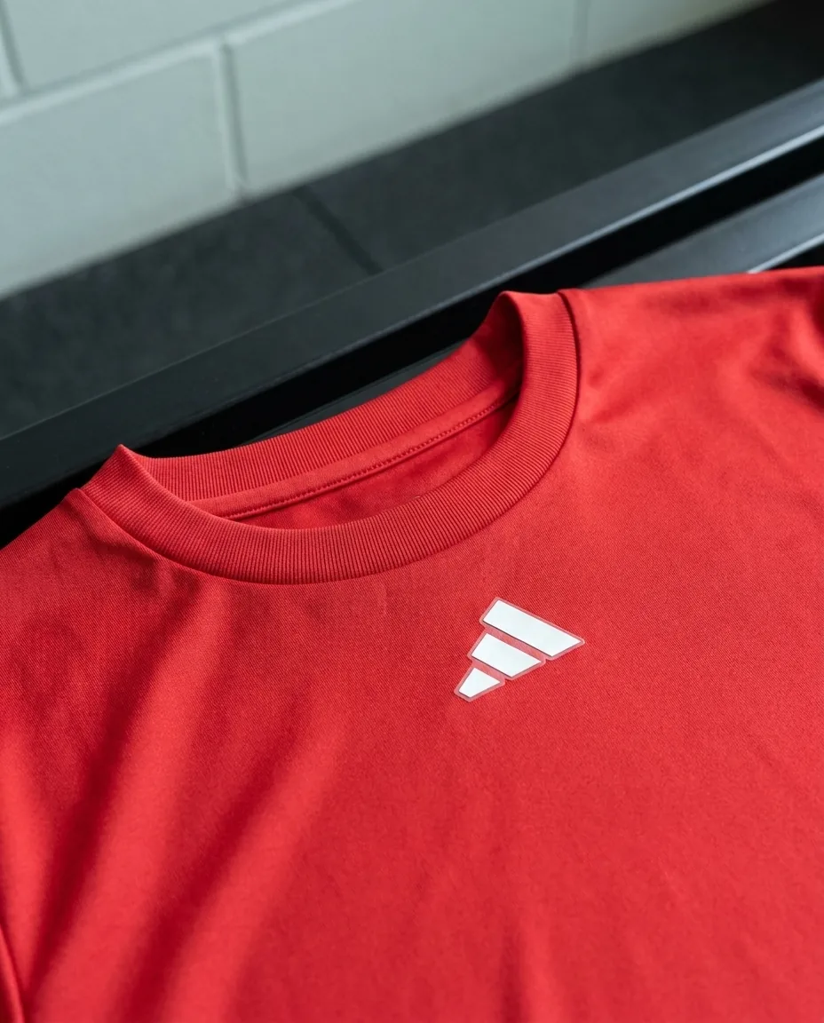 Custom Adidas shirts close-up, Power Red recycled polyester knit, rib collar and adidas chest badge