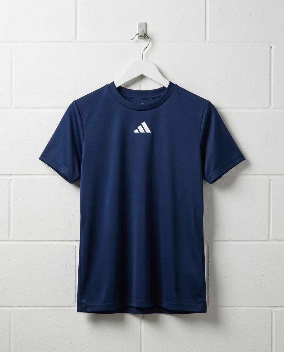 Custom Adidas shirts for women, Team Navy Pregame performance tee on a hanger showing the centre chest adidas badge