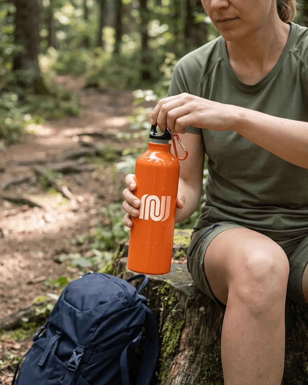 Custom aluminum water bottle with a printed logo in use