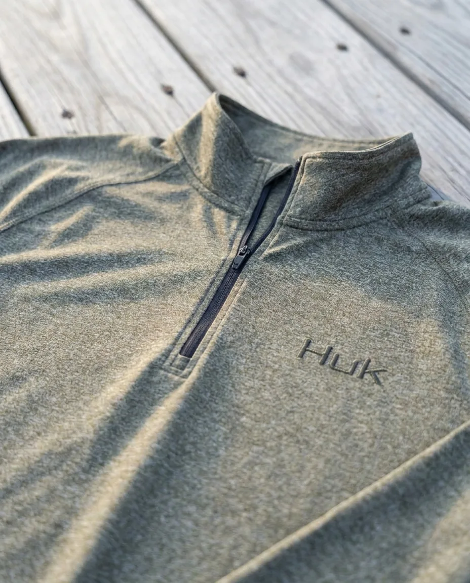 Custom embroidered quarter zips close-up, HUK heather knit, mock collar, coil zipper and blank right chest ready for embroidery