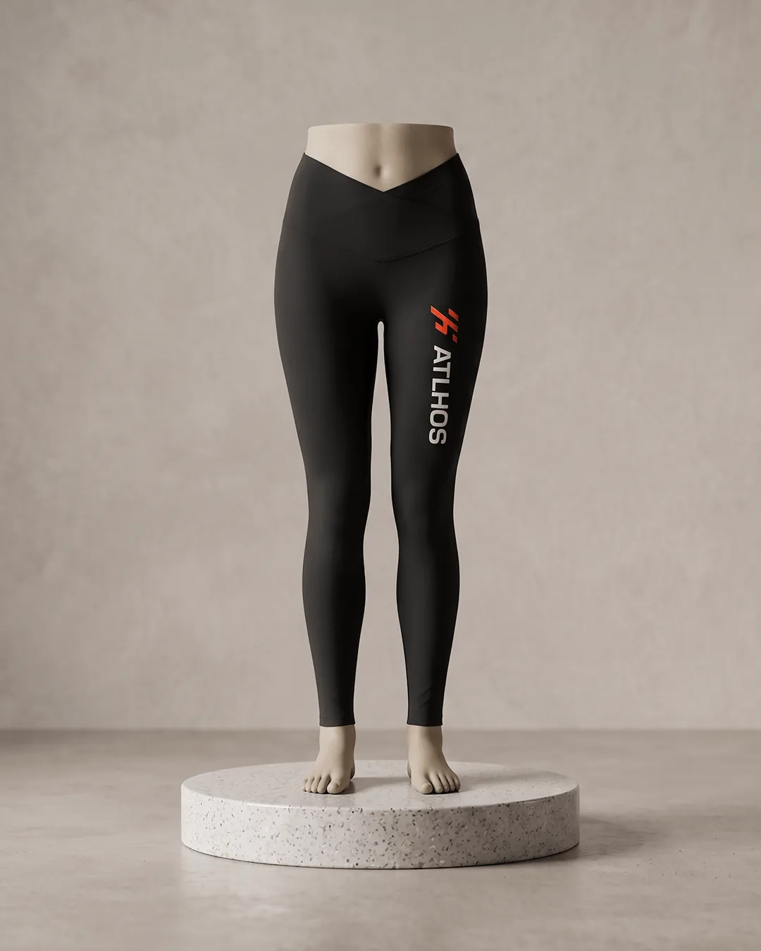 Front view of custom high-rise leggings in Black on a form, with a vertical orange and white logo printed on the upper left leg