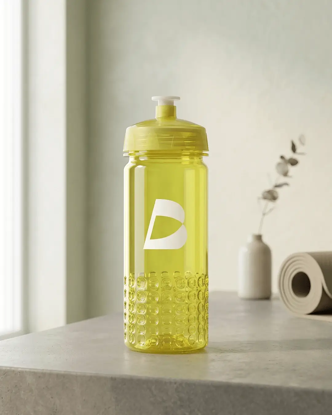 Custom team water bottle in translucent yellow with a white printed logo on a stone counter